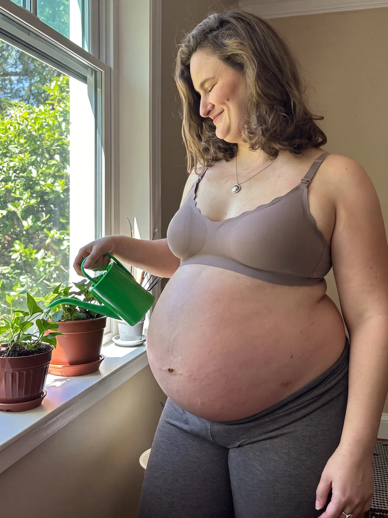 Pregnant mom watering plants in the Aura Comfort Bra in Grey Purple