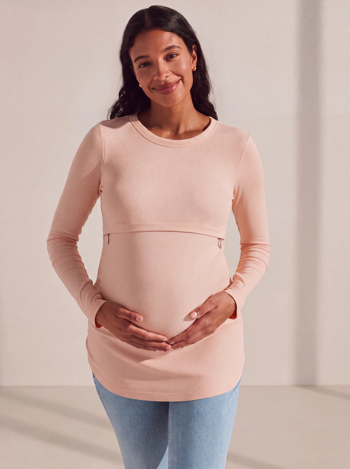 Pregnant woman in the blush pink nursing tee in the studio
