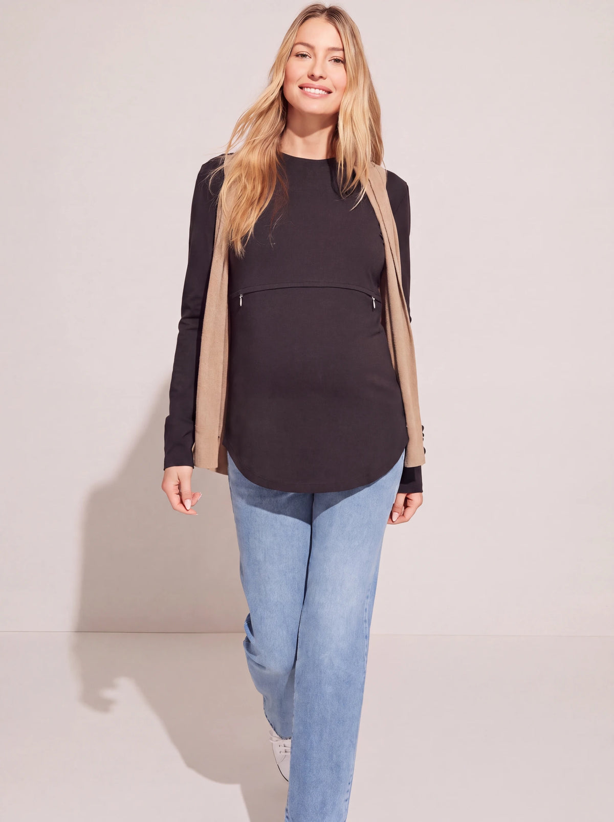 Black nursing tee worn with an open camel cardigan and jeans