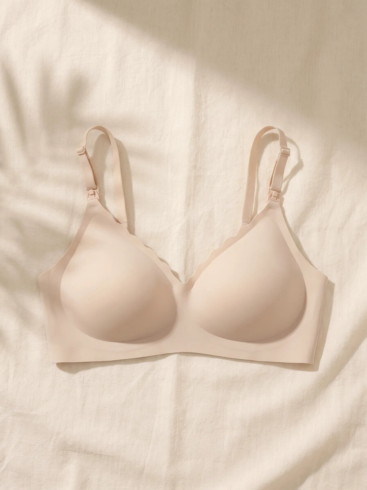 Aura Ultra Soft Comfort Bra in Skin laid flat on linen