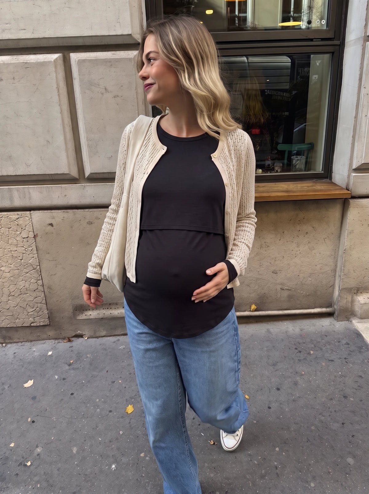 Black nursing top styled with a beige cardigan and jeans