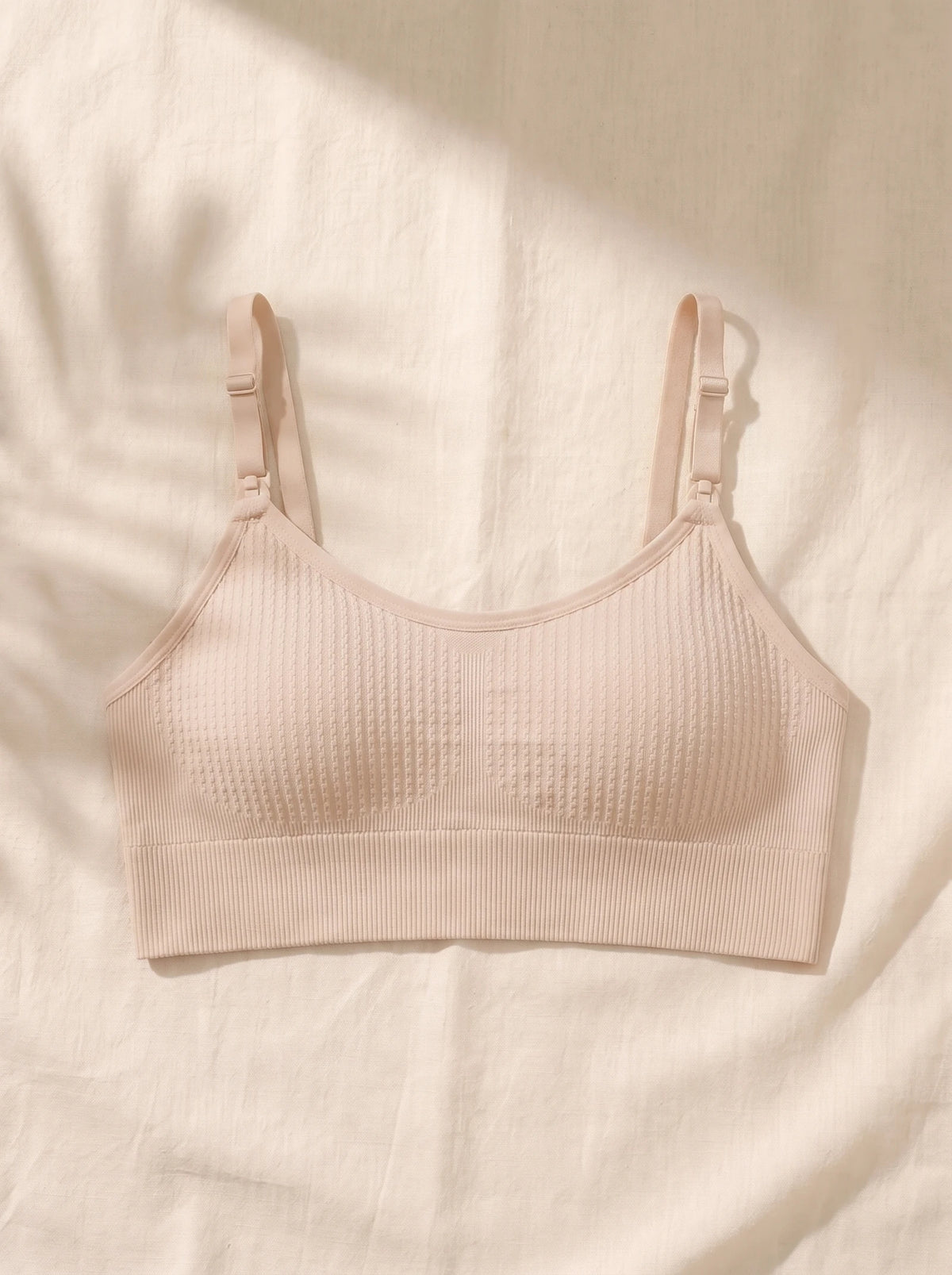 AURA nursing bra in Skin laid flat on linen