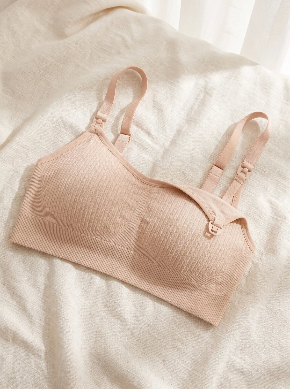 Aura Nursing Bra in Skin laid flat on linen
