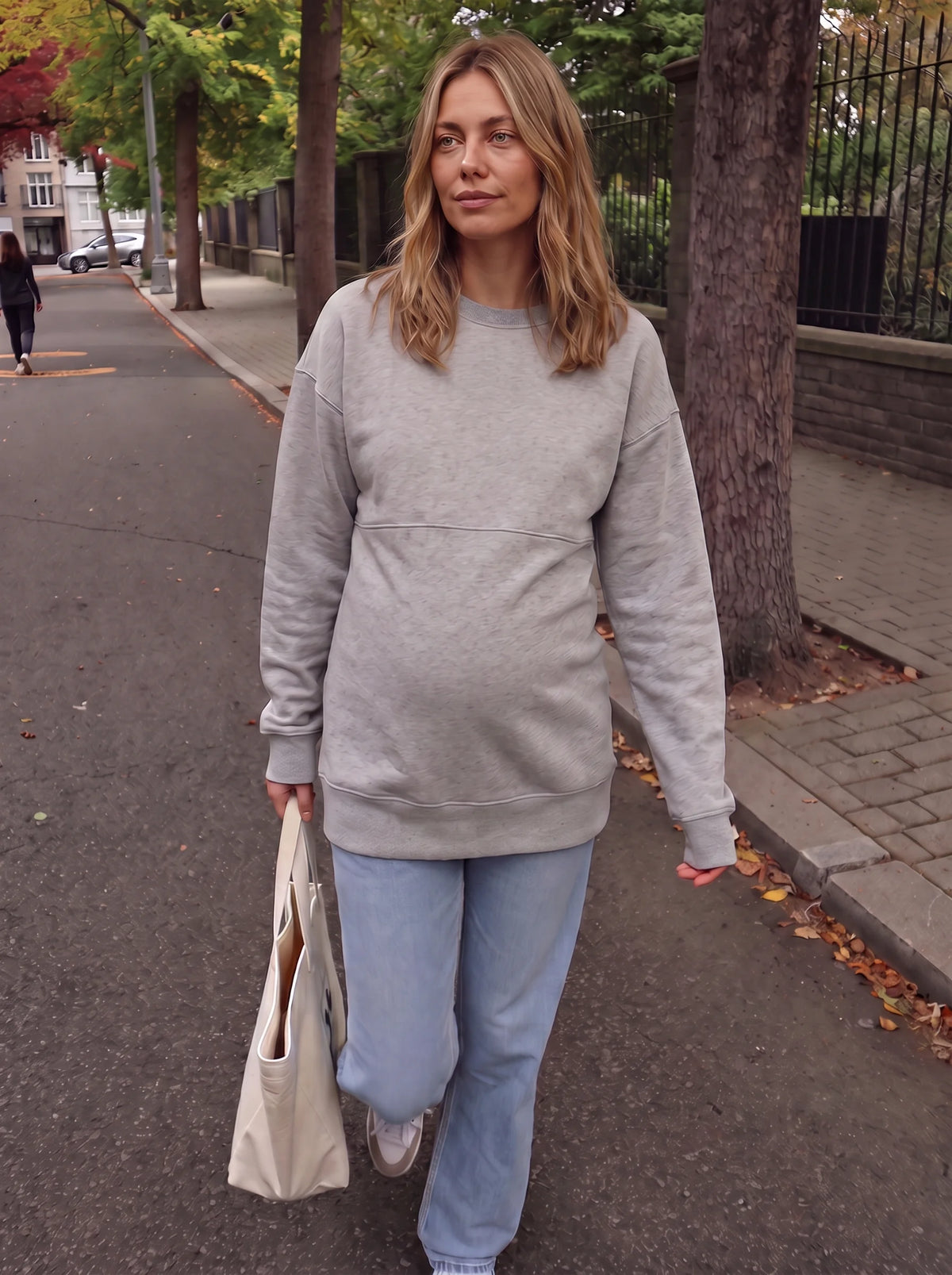 Mom walking on an autumn street in gray hidden zip sweatshirt