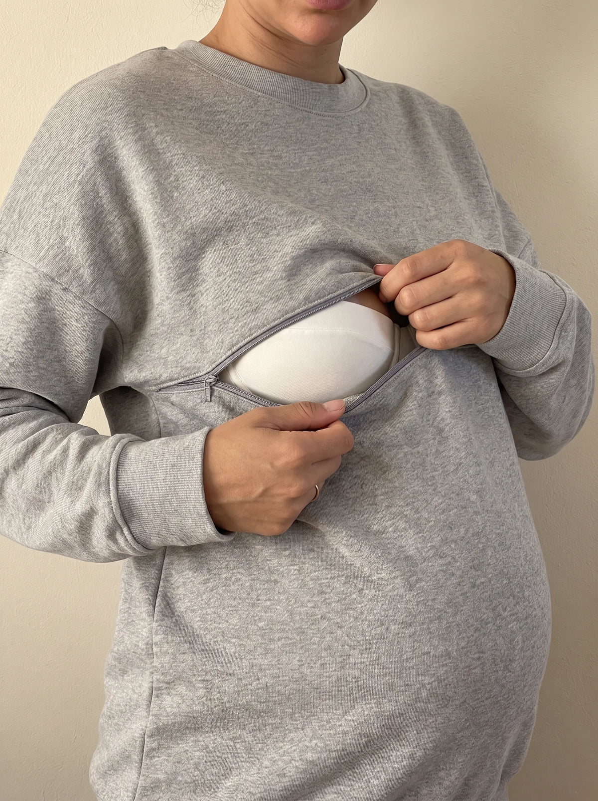 Hidden chest zip opened for breastfeeding, zipper visible