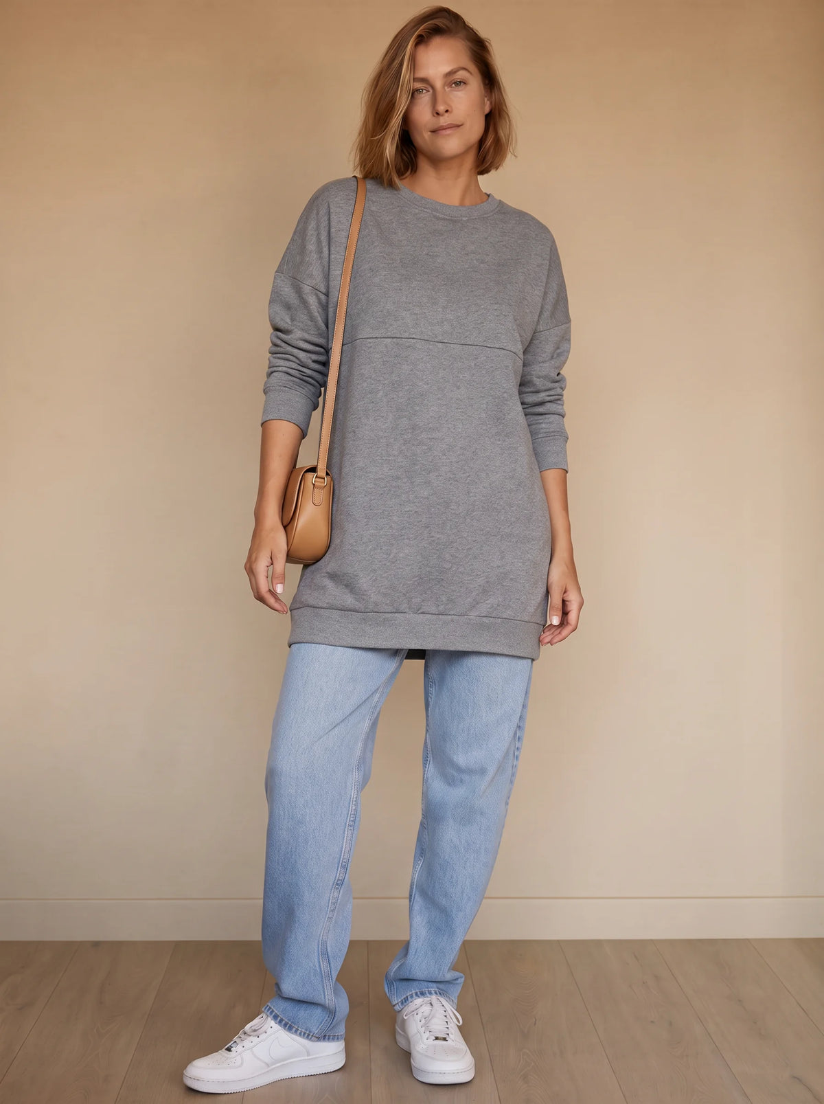 Nursing sweatshirt styled with jeans and a crossbody bag